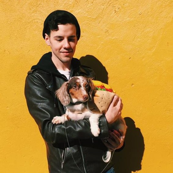 Me holding my dog in a hot dog costume